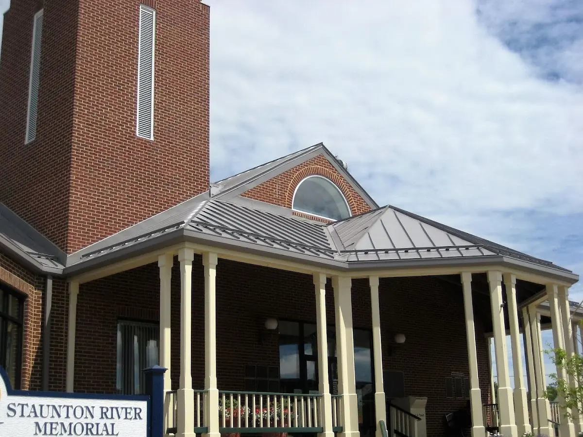 Skilled roofing craftsmen working on a residential roof in Escanaba